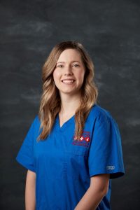 Amanda Wright from Nursing team smiling and wearing blue nurse suit