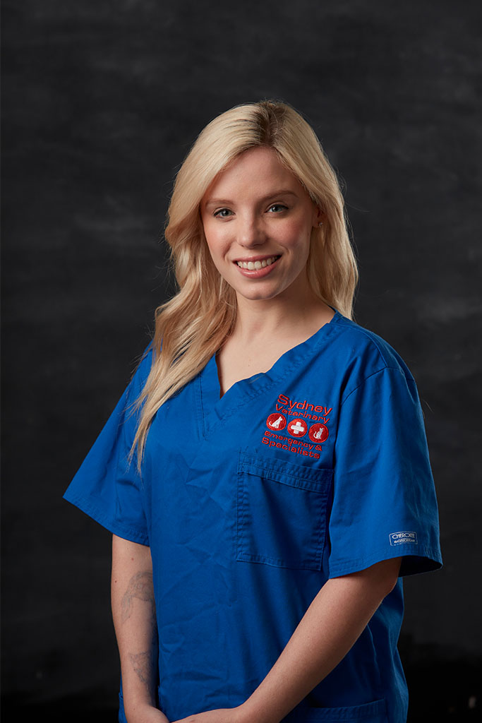 Alyssa Macfarlane from Nursing team smiling and wearing blue nurse suit